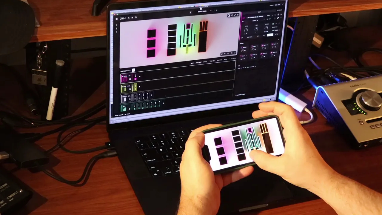Playing DRUW on a phone in front of a laptop
